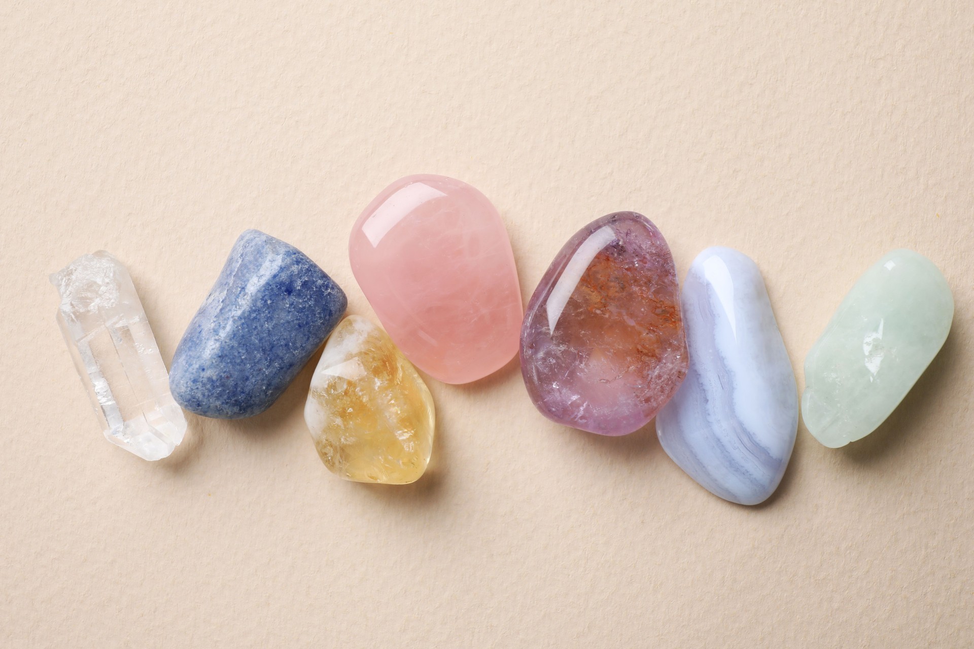 Beautiful gemstones on beige table, flat lay. Healing crystals