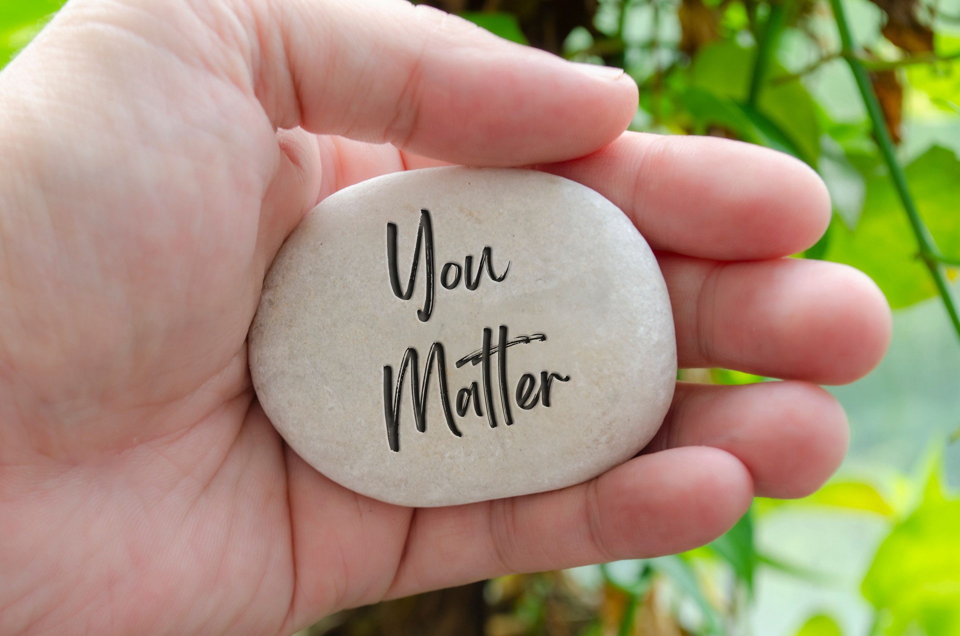 You Matter text engraved on white stone. Motivational and inspirational concept